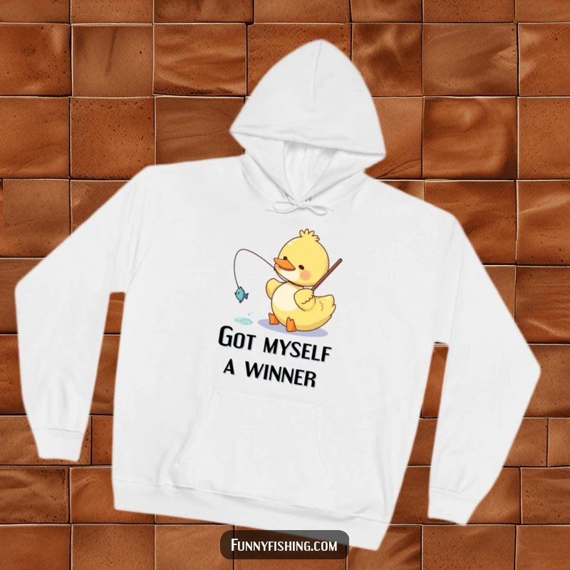 Funny duck hoodie featuring a happy duck character proudly reeling in a small, sparkling fish, perfect for warm and humorous wear.