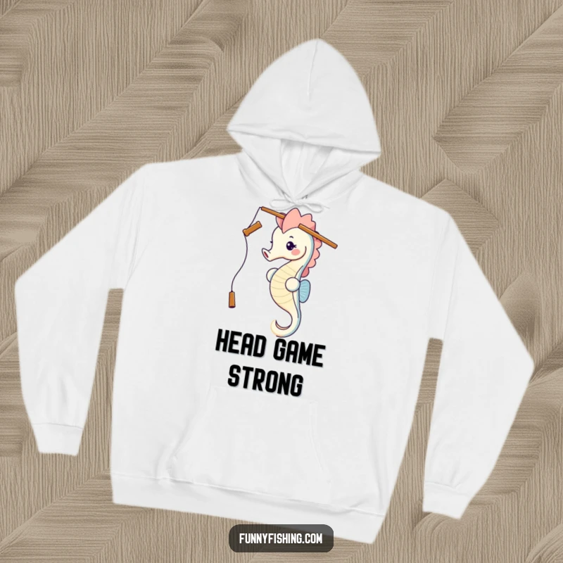 A happy seahorse humorously balancing a fishing rod on its head, featured on a soft, warm hoodie, ready for chill vibes and laughs.