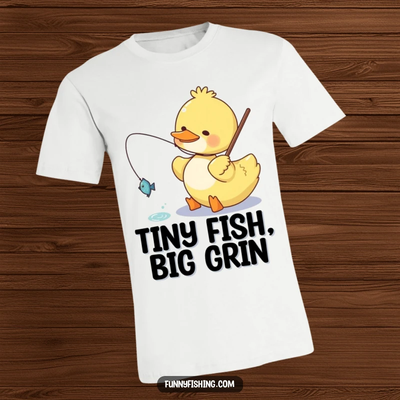 Funny duck t-shirt illustrating a cheerful duck character happily reeling in a small, glittering fish, ideal for fishing fans and humor lovers.
